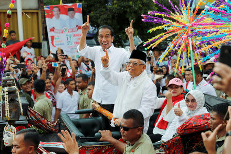 FILE PHOTO: Indonesia's President and presidential candidate for the next election Joko Widodo and his running mate for the upcoming election Ma'ruf Amin gesture as they greet their supporters at a carnival during campaign rally in Tangerang, Banten province, Indonesia, April 7, 2019. REUTERS/Willy Kurniawan/File Photo