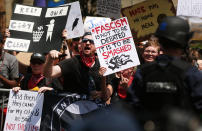 <p>Hundreds of protesters demonstrate against a Confederate monument in Fort Sanders as a smaller number of pro-confederate supporters stand against the removal of the memorial monument on Aug. 26, 2017 in Knoxville, Tenn. (Photo: Spencer Platt/Getty Images) </p>