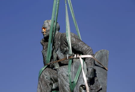 The statue of Cecil John Rhodes is bound by straps as it awaits removal from the University of Cape Town (UCT), April 9, 2015. REUTERS/Mike Hutchings