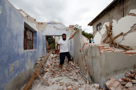 Mario Castro explains how he survived with his son inside his house destroyed by the earthquake that struck the southern coast of Mexico late on Thursday, in Ixtaltepec, Mexico, September 10, 2017. REUTERS/Carlos Jasso