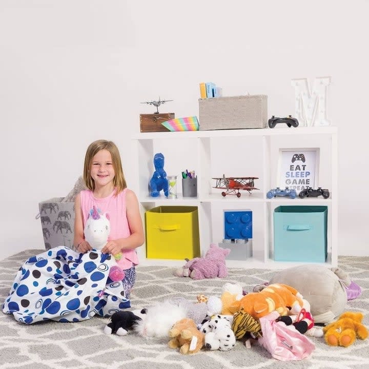 child model puts stuffed animals into a bag