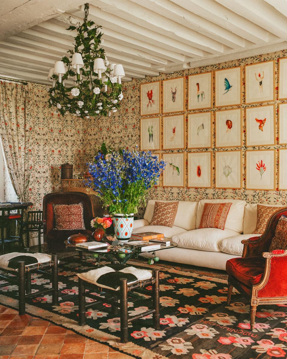 In the main salon, a blend of vintage furnishings, including a vibrant rug from the Paris flea market, mix with a Bespoke sofa. Moroccan Stools.
