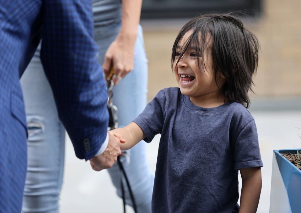 James Ramirez gets a handshake after his mother spoke about them living at The Aster during a ribbon-cutting ceremony for the three-building development that includes low-income housing, commercial and public spaces, in Salt Lake City on Tuesday, May 2, 2023. | Kristin Murphy, Deseret News