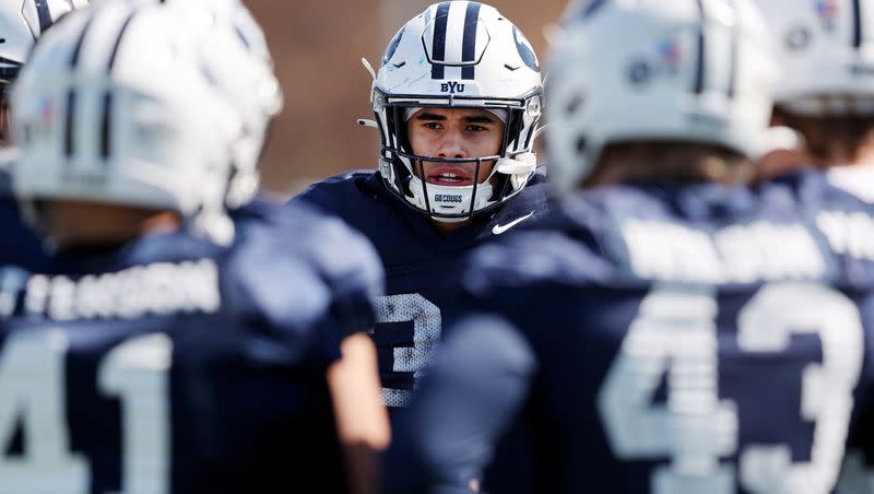 BYU linebacker Maika Kaufusi listens to position coach Justin Ena after the Cougars practice in Provo on Friday, March 17, 2023.