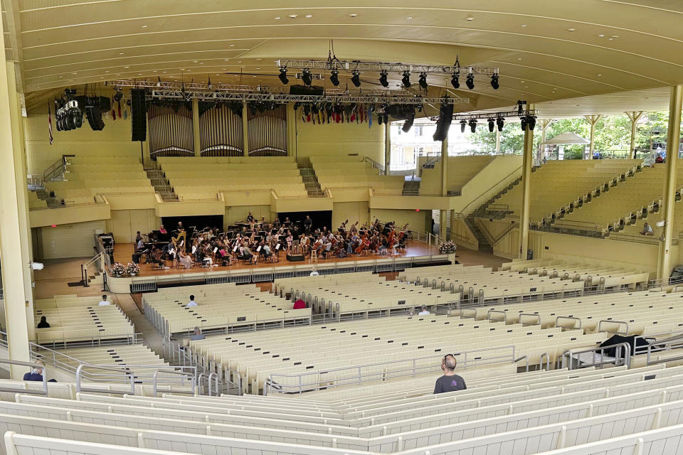 The Chautauqua Symphony Orchestra rehearses in the Chautauqua Institution's 4,400-seat open air amphitheater, whose summer entertainment lineup includes concerts by Diana Ross and Bonnie Raitt, ballet and theater productions, in Chautauqua, NY, Thursday, June 29, 2023. For a single, unthinkable moment last summer, the Chautauqua Institution was a hostile place for the freedom of expression that's been its hallmark for 150 years: As Salman Rushdie was about to speak, an audience member leapt onto the stage and stabbed the celebrated author more than a dozen times. (AP Photo/Carolyn Thompson)