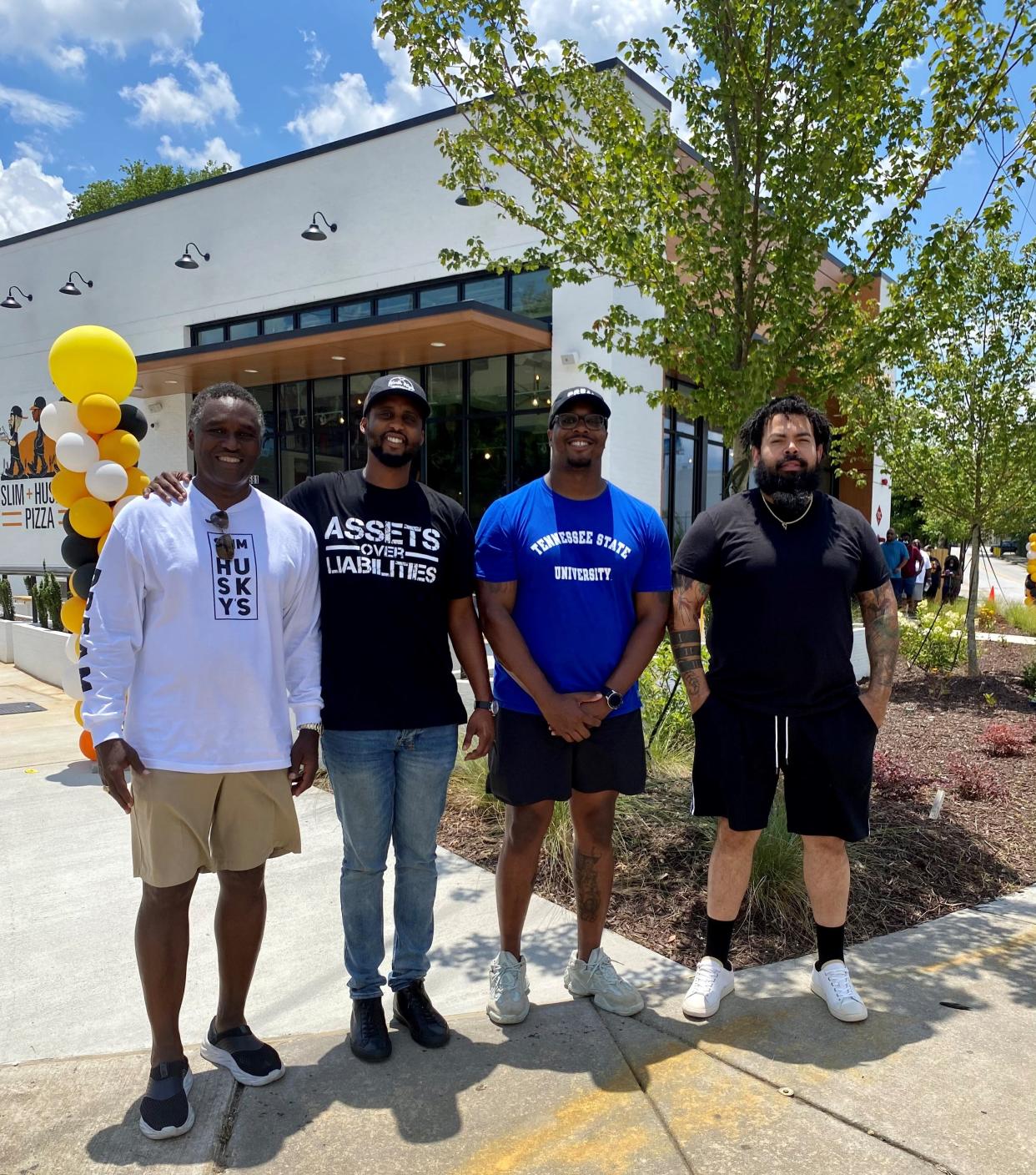 Businessman Darrell Freeman, left, poses with the owners of Slim & Husky's in March 2020 outside a new location in Atlanta. They are, from left, Freeman, E.J. Reed, Derrick "Moe" Moore and Clint Gray.