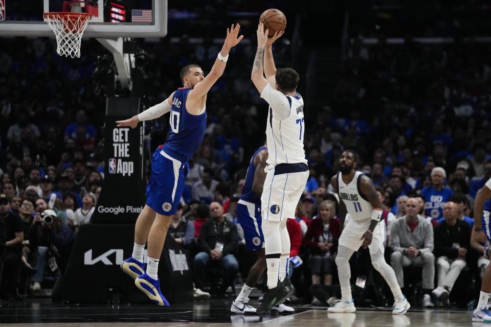 Dallas Mavericks guard Luka Doncic (77) shoots against LA Clippers center Ivica Zubac (40) during the first half of Game 1 of an NBA basketball first-round playoff series in Los Angeles, Sunday, April 21, 2024. (AP Photo/Ashley Landis)