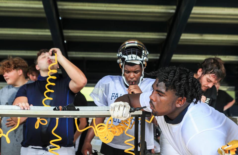 Fairdale High School football players take a water break on a hot afternoon recently. Due to the heat index that day, the team's practice was cut short. The Bulldogs' undefeated season last year was derailed by Covid-19.  August 8, 2021