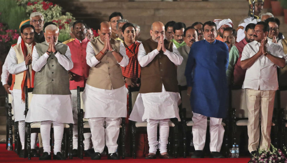 Indian Prime Minister Narendra Modi, left, with newly sworn his cabinet ministers greet the invitees at the end of the swearing in ceremony at the forecourt of presidential palace in New Delhi, India, Thursday, May 30, 2019. Modi was sworn in Thursday for a second term after an overwhelming election victory for his Hindu nationalist party in a country of 1.3 billion people seeking swift economic change. (AP Photo/Manish Swarup)
