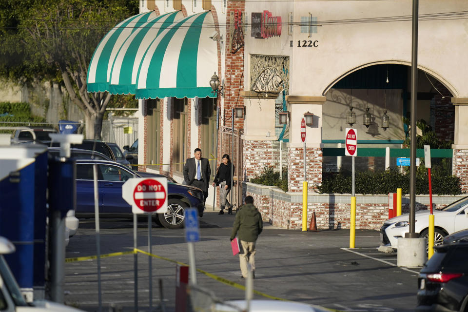 Investigators are seen outside Star Dance Studio in Monterey Park, Calif., Sunday, Jan. 22, 2023. A mass shooting took place at the dance club following a Lunar New Year celebration, setting off a manhunt for the suspect. (AP Photo/Jae C. Hong)