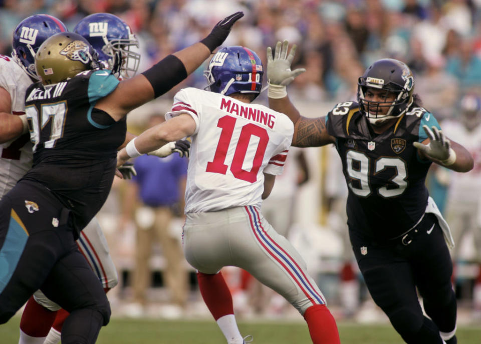 Nov 30, 2014; Jacksonville, FL, USA; Jacksonville Jaguars defensive tackle Roy Miller (97) and defensive end Tyson Alualu (93) sack New York Giants quarterback Eli Manning (10) in the fourth quarter at EverBank Field. The Jaguars won 25-24. Mandatory Credit: Phil Sears-USA TODAY Sports