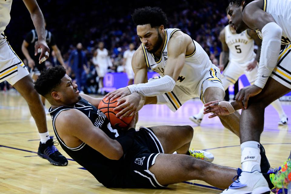 Providence's Ed Croswell, left, secures a rebound against Villanova's Caleb Daniels during the second half of an NCAA college basketball game, Sunday, Jan. 29, 2023, in Philadelphia. (AP Photo/Derik Hamilton)