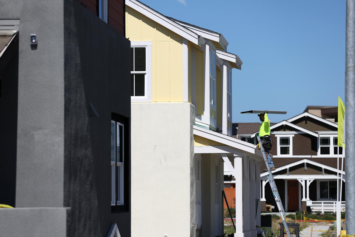 PETALUMA, CALIFORNIA - MARCH 23: A construction worker carries materials as he works on a home under construction at a housing development on March 23, 2022 in Petaluma, California. According to a report by the Commerce Department, sales of new single-family homes slowed in February as mortgage rates inch up and and house prices continue to rise. (Photo by Justin Sullivan/Getty Images)