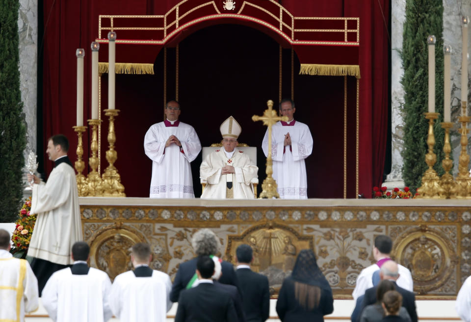 Don Ezio Bolis, Director of the John XXIII foundation and the Roncalli family, carries the relic of Pope John XXIII past Pope Francis, during a solemn ceremony in St. Peter's Square at the Vatican, Sunday, April 27, 2014. Pope Francis has declared his two predecessors John XXIII and John Paul II saints in an unprecedented canonization ceremony made even more historic by the presence of retired Pope Benedict XVI. (AP Photo/Domenico Stinellis)