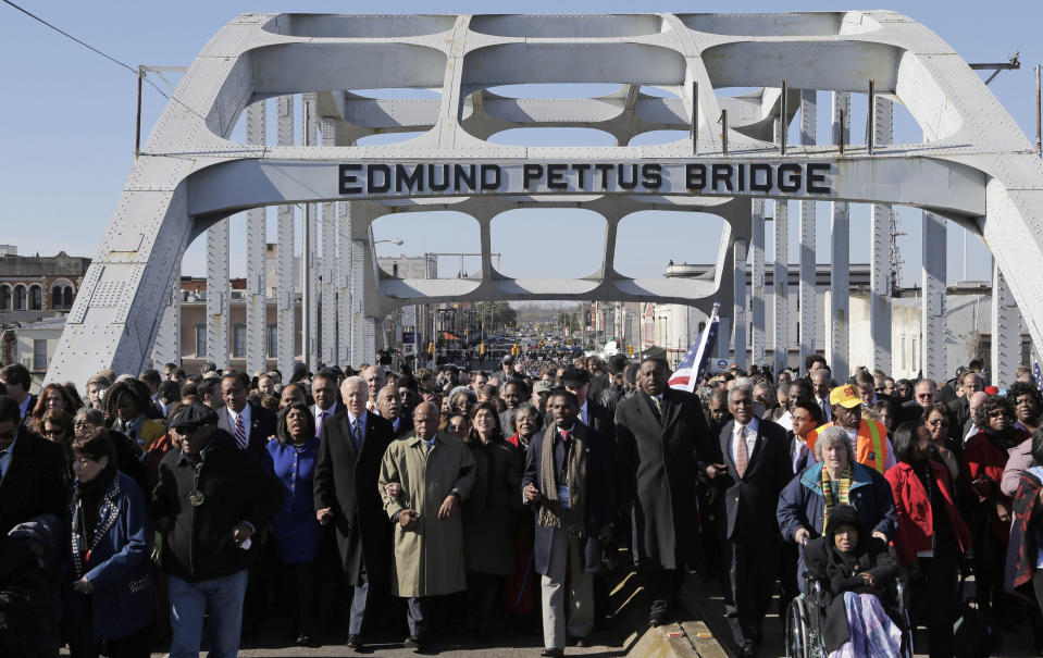 FILE - Vice President Joe Biden and U.S. Rep. John Lewis, D-Ga., lead a group across the Edmund Pettus Bridge in Selma, Ala., Sunday, March 3, 2013. Biden will travel to Alabama on Sunday, March 5, 2023, to mark the 58th anniversary of a landmark event of the civil rights movement. The visit comes as the city that served as a crucible of the civil rights movement is fighting to recover from a January tornado. (AP Photo/Dave Martin, File)