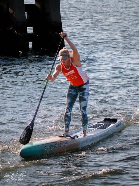 Kim Barnes, racing May 17, 2022 in Jupiter, Florida during a Tuesday night race league hosted by Blueline Paddle Surf, is headed to Detroit to compete in the Belle Isle Classic in July. She is a top-ranked competitor in distance 
paddle boarding.