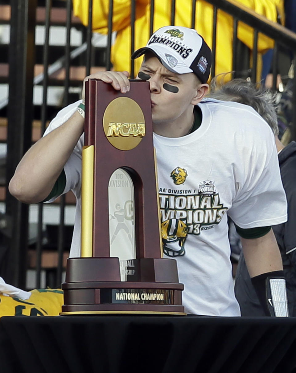 North Dakota State quarterback Brock Jensen kisses the game trophy after being honored as the Most Outstanding Player of the FCS championship NCAA college football game against Towson, Saturday, Jan. 4, 2014, in Frisco, Texas. NDSU won 35-7. (AP Photo/Tony Gutierrez)