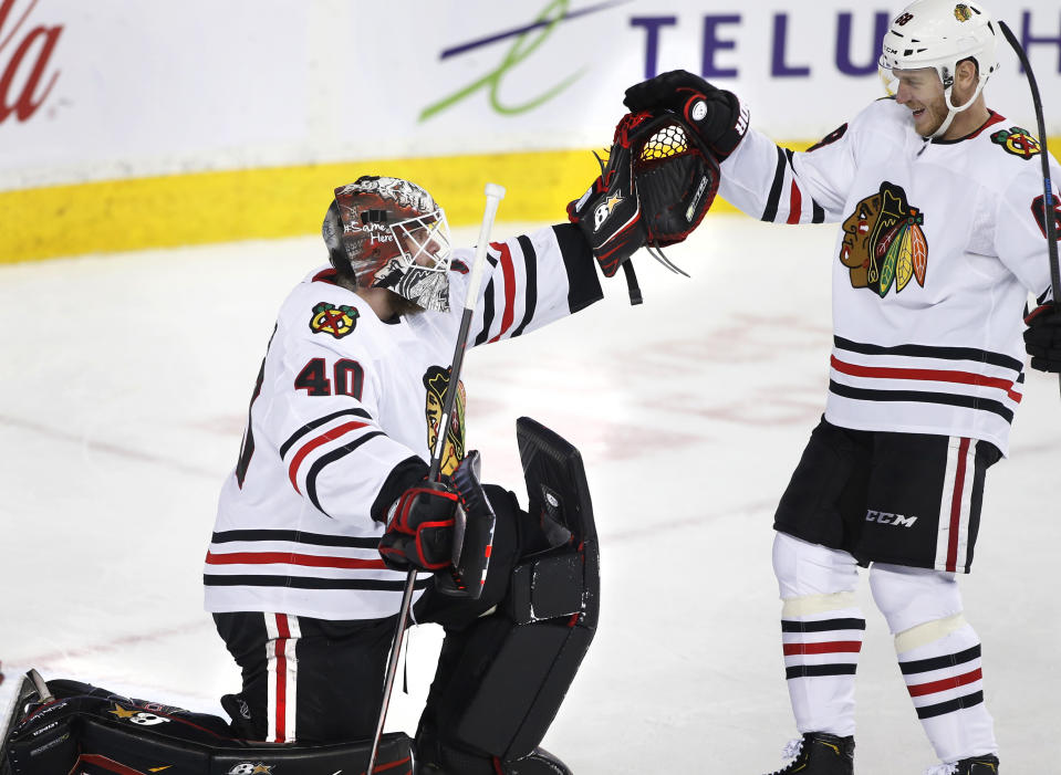 Chicago Blackhawks goalie Robin Lehner, from Sweden, is congratulated by defenseman Slater Koekkoek (68) after the Blackhawks defeated the Calgary Flames in an NHL hockey game Saturday, Feb. 15, 2020, in Calgary, Alberta. (Larry MacDougal/The Canadian Press via AP)