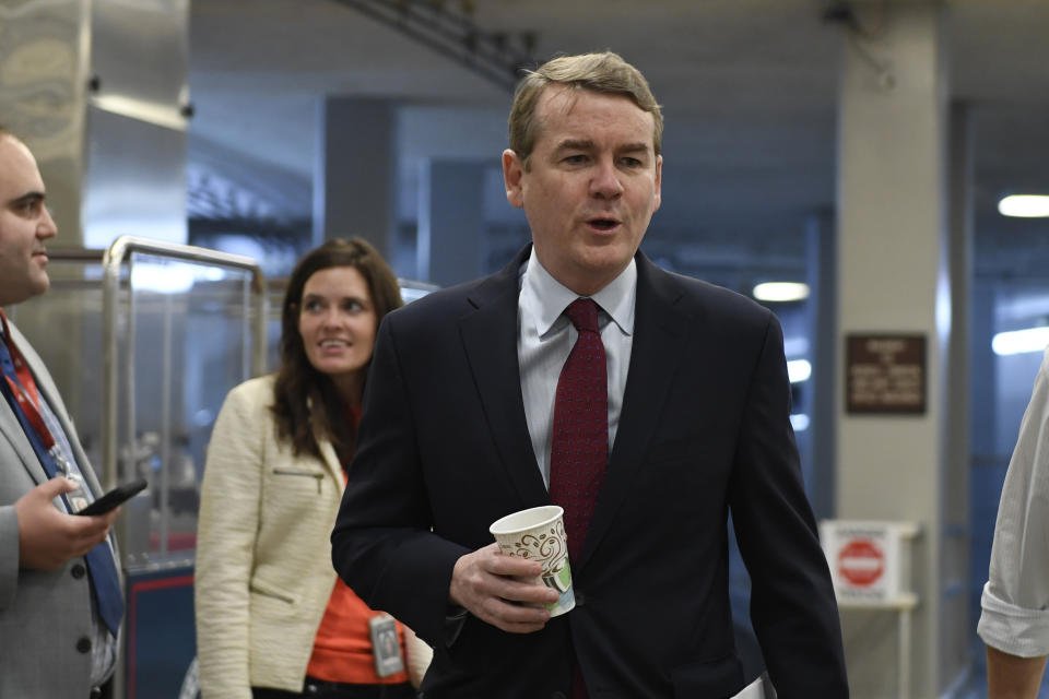 Sen. Michael Bennet, D-Colo., walks on Capitol Hill in Washington, Tuesday, Dec. 17, 2019. (AP Photo/Susan Walsh)