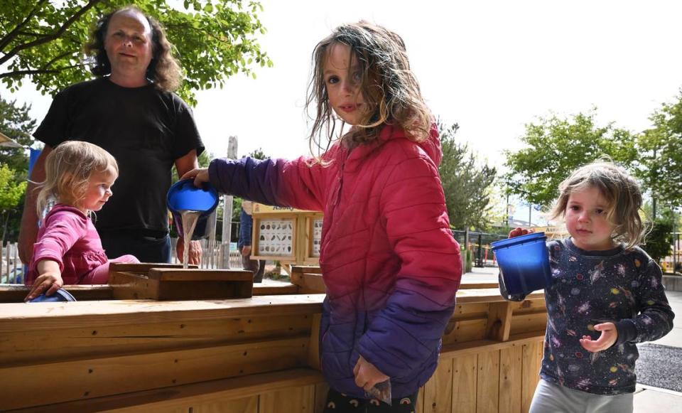 Chris Allert plays with his daughters (from left) Susanna, 3, Amira, 7, and Rachel Corrie, 4, at the Hands On Childrens Museum in Olympia on Friday, May 13. After living in hotel rooms and moving every couple of weeks, Allert received help getting an apartment through a Go Fund Me account.