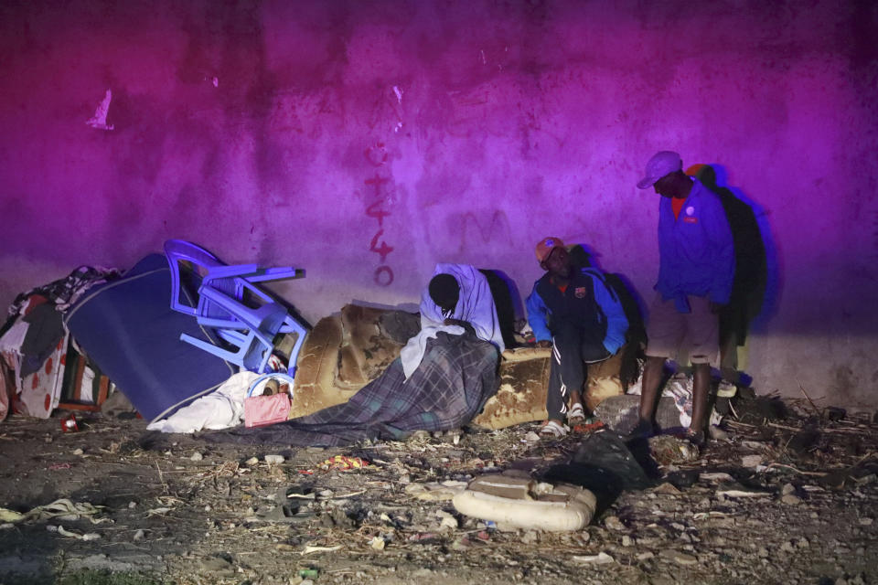 Residents salvage what is left of their property following a fire caused by a vehicle loaded with gas which exploded, in Nairobi, Kenya, Friday, Feb. 2, 2024. The truck explosion ignited a huge fireball, and a flying gas cylinder set off a fire that burned down the Oriental Godown, a warehouse that deals with garments and textiles, according to government spokesman Isaac Mwaura. (AP Photo)