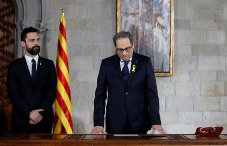 FILE PHOTO: Quim Torra takes his oath as new Catalan Regional President next to regional parliament speaker Roger Torrent during a ceremony at Generalitat Palace in Barcelona, Spain, May 17, 2018. Alberto Estevez/Pool via REUTERS