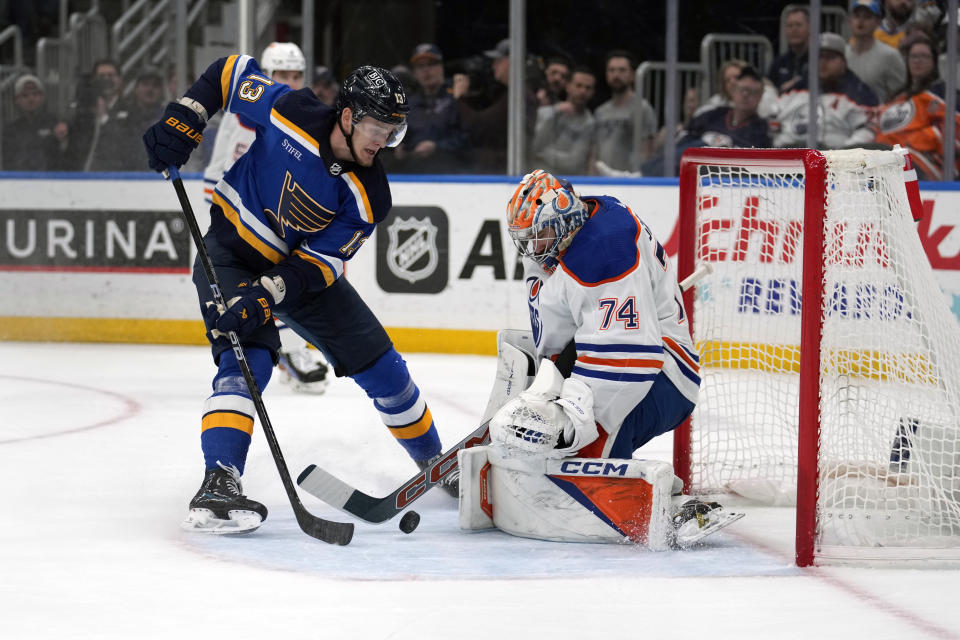 St. Louis Blues' Alexey Toropchenko (13) is unable to score past Edmonton Oilers goaltender Stuart Skinner (74) during the second period of an NHL hockey game Monday, April 1, 2024, in St. Louis. (AP Photo/Jeff Roberson)