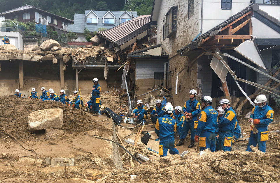 <p>Emergency teams rest outside of structural damage caused by heavy rains, July 9, 2018, in Hiroshima, Japan. (Photo: Haruka Nuga/AP) </p>