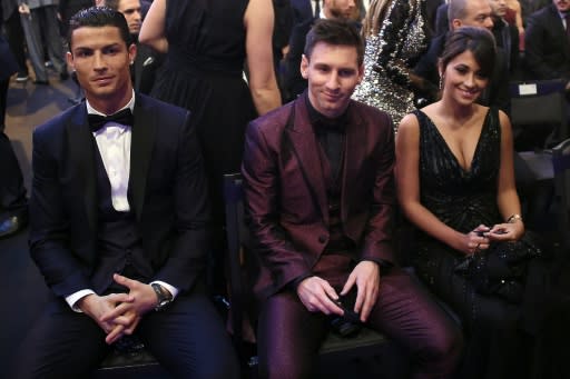 Cristiano Ronaldo (I), Lionel Messi (C) y su esposa Antonella Rocuzzo durante la eceremonia de entrega de Balón de Oro de la FIFA 2014, el 12 de enero de 2015 en Zúrich (AFP | Olivier Morin)