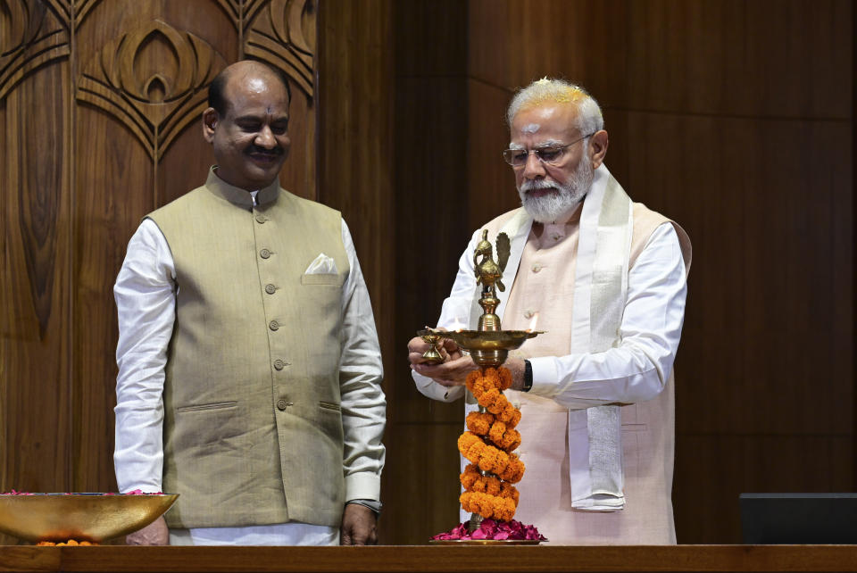 Indian prime minister Narendra Modi lights a lamp after installing a royal golden sceptre near the chair of the speaker, as speaker of the lower house Om Birla watches, during the start of the inaugural ceremony of the new parliament building, in New Delhi, India, Sunday, 28 May 2023. The new triangular parliament building, built at an estimated cost of $120 million, is part of a $2.8 billion revamp of British-era offices and residences in central New Delhi called "Central Vista", even as India's major opposition parties boycotted the inauguration, in a rare show of unity against the Hindu nationalist ruling party that has completed nine years in power and is seeking a third term in crucial general elections next year. (AP Photo)