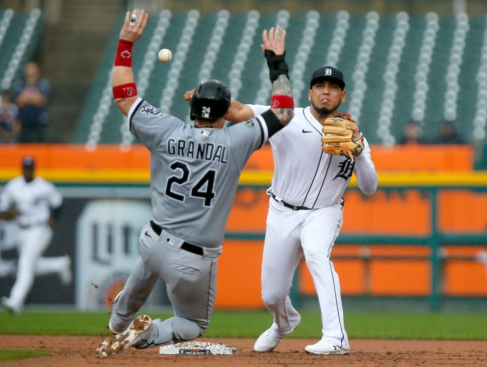 Detroit Tigers second baseman Isaac Paredes, right, turns the ball for a double play after getting a force out on Chicago White Sox's Yasmani Grandal during the third inning of a baseball game Tuesday, Sept. 21, 2021, in Detroit. Eloy Jimenez hit into the double play.