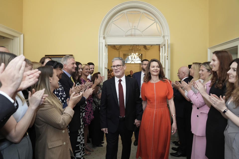 Britain's newly elected Prime Minister Keir Starmer and his wife Victoria enter his official London residence at No 10 Downing Street for the first time after the Labour Party won a landslide victory in the 2024 general election, in London, Friday July 5, 2024. (Stefan Rousseau/Pool Photo via AP)