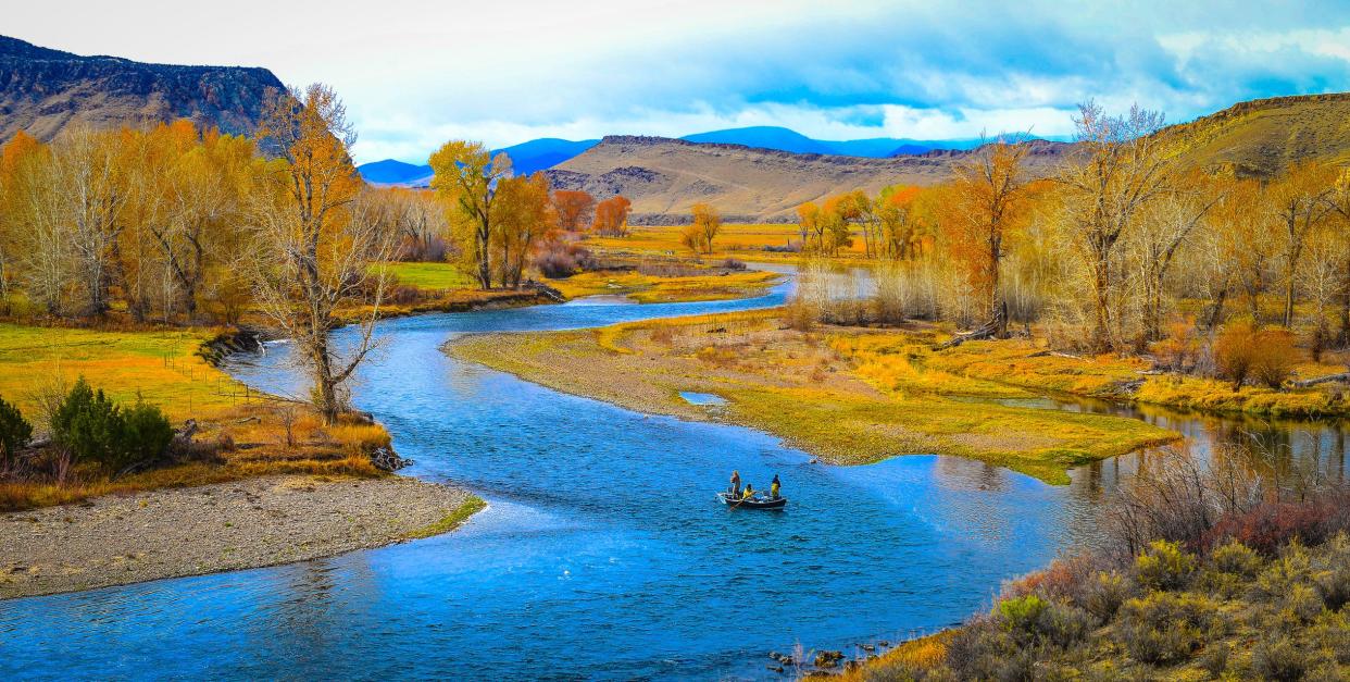 River landscape with a drift fishing boat