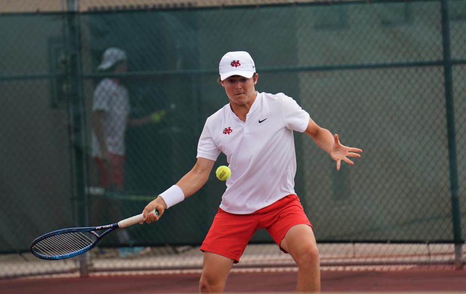 Vero Beach's Bo Johnson hits a return during the District 10-4A Tennis Championships held at Whispering Pines Park on Tuesday, April 11, 2023 in Port St. Lucie.