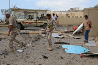 Soldiers stand guard at the site of a car bomb attack outside the headquarters of a counter-terrorism unit in Aden, Yemen February 25, 2018. REUTERS/Fawaz Salman