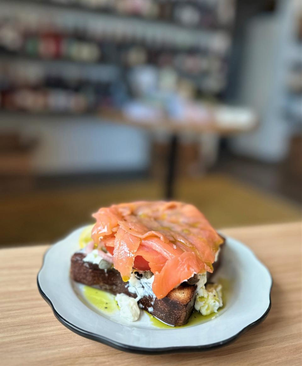 Smoked salmon lays across a fat tomato slice on a dish at Golden Hour.