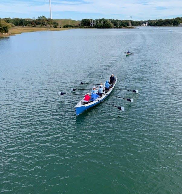 One of the Dharma Voyage rowing teams from Westport head up the Weir River in Hull on Saturday, Oct. 14.