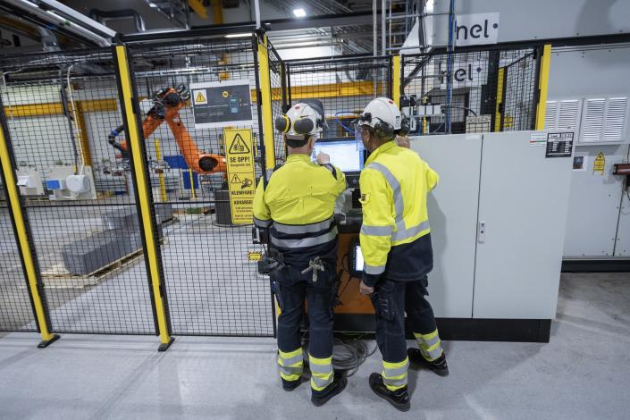 Employees work at a facility for the Norwegian company Nel in Heroya, Norway, on April 20, 2023. Nel makes devices that take water and split it into hydrogen and oxygen, known as electrolyzers, as well as fueling stations. The company announced plans Wednesday, May 3, to build a massive new plant in Michigan as it works with General Motors to drive down the cost of hydrogen. (AP Photo/Trond R. Teigen)