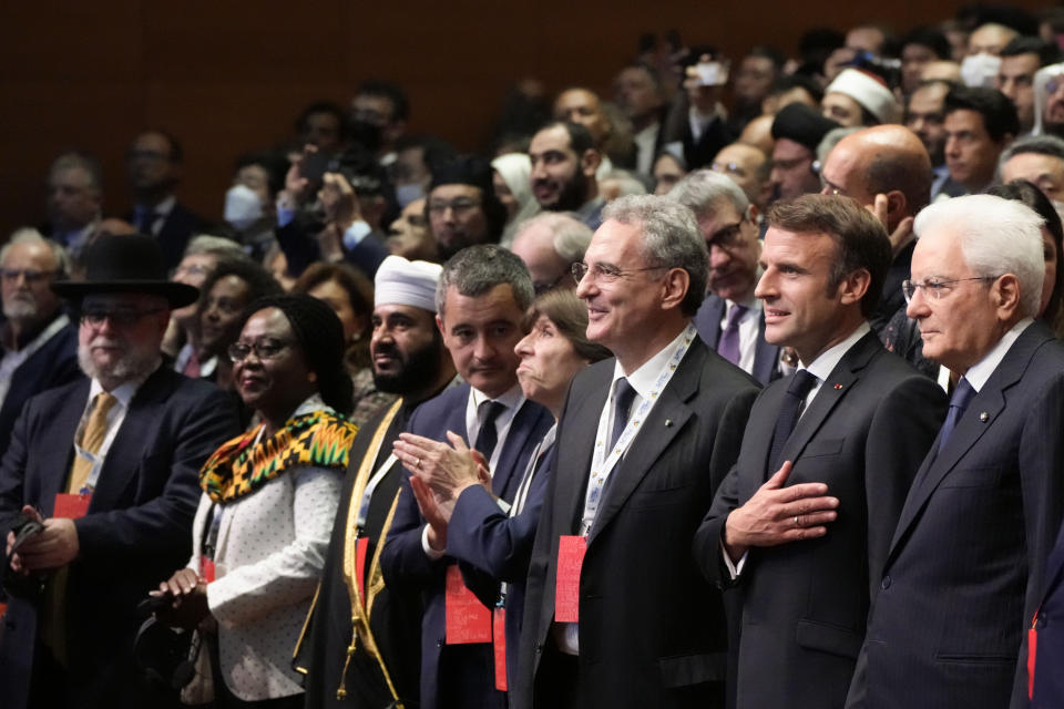 French President Emmanuel Macron, second right, is flanked at right by Italian president Sergio Mattarella as they arrive at "Cry for peace" an international conference for peace organized by the Community of Sant'Egidio in Rome, Sunday, Oct. 23, 2022. (AP Photo/Alessandra Tarantino)