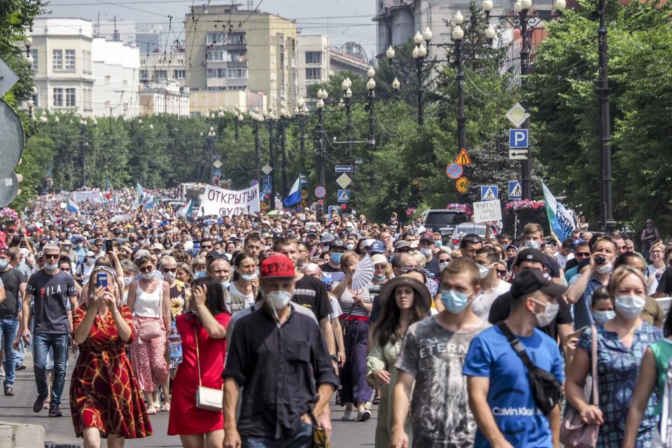 People march during an unsanctioned protest in support of Sergei Furgal, the governor of the Khabarovsk region, in Khabarovsk, 6100 kilometers (3800 miles) east of Moscow, Russia, Saturday, July 18, 2020. Tens of thousands of people in the Russian Far East city of Khabarovsk took to the streets on Saturday, protesting the arrest of the region's governor on charges of involvement in multiple murders. Local media estimated the rally in the city attracted from 15,000 to 50,000 people. (AP Photo/Igor Volkov)