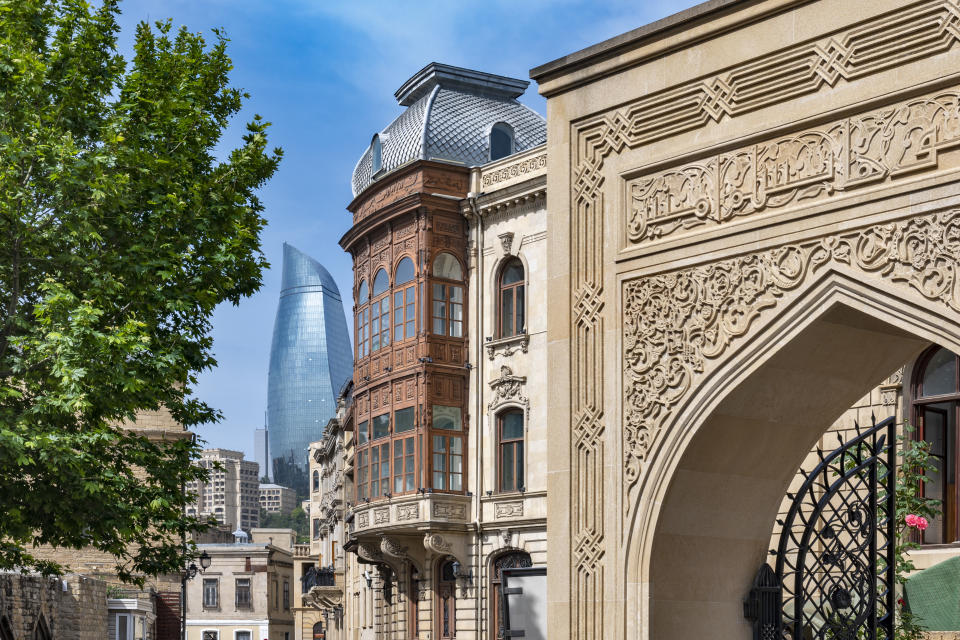 View of the Cuma Mosque, old house and Flam towers in the morning in Baku, Azerbaijan