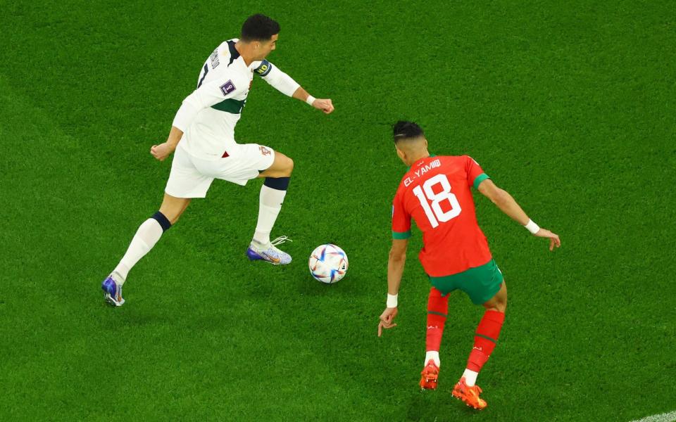 Portugal's Cristiano Ronaldo in action with Morocco's Jawad El Yamiq - REUTERS