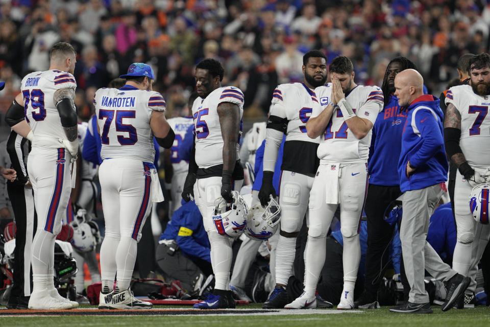 Buffalo Bills quarterback Josh Allen (17) pauses as Damar Hamlin is examined during the first half of an NFL football game against the Cincinnati Bengals, Monday, Jan. 2, 2023, in Cincinnati. (AP Photo/Jeff Dean)