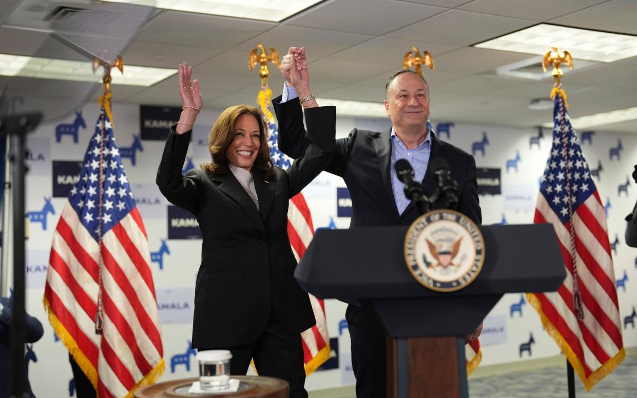 Kamala Harris, left, and second gentleman Doug Emhoff address staff at her campaign headquarters in Wilmington