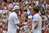 Tennis - Wimbledon - All England Lawn Tennis and Croquet Club, London, Britain - July 13, 2018 South Africa's Kevin Anderson shakes hands with John Isner of the U.S. after winning their semi final match REUTERS/Tony O'Brien