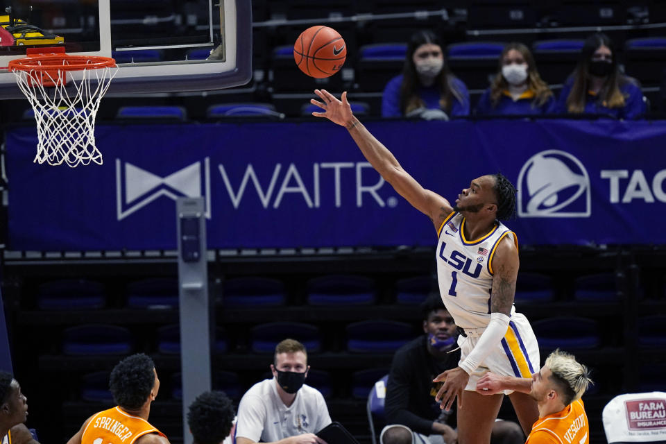 LSU guard Ja'Vonte Smart (1) goes to the basket over Tennessee guard Santiago Vescovi in the second half of an NCAA college basketball game in Baton Rouge, La., Saturday, Feb. 13, 2021. (AP Photo/Gerald Herbert)