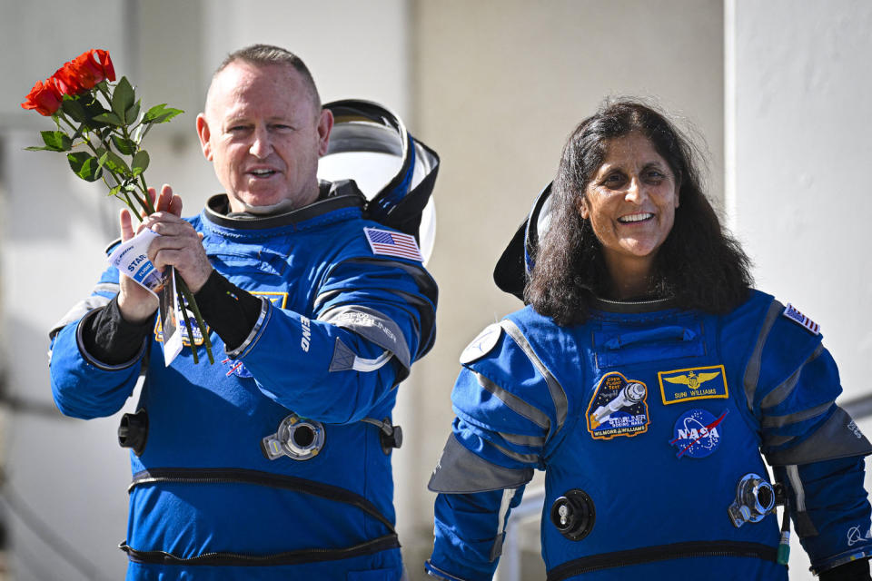 Butch Wilmore left, and Suni Williams wearing Boeing spacesuits, smile as they prepare to depart the Neil A. Armstrong Operations and Checkout Building at Cape Canaveral Space Force Station Kennedy Space Center in Florida (Miguel J. Rodriguez Carrillo / AFP - Getty Images)