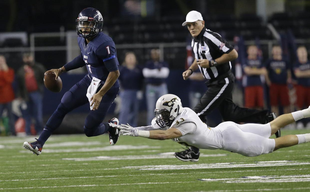 Allen quarterback Kyler Murray (1) eludes Cypress Ranch linebacker Brayden Stringer (33) during the first half of the UIL 6A Division I state championship football game Saturday, Dec. 20, 2014, in Arlington, Texas. (AP Photo/LM Otero)