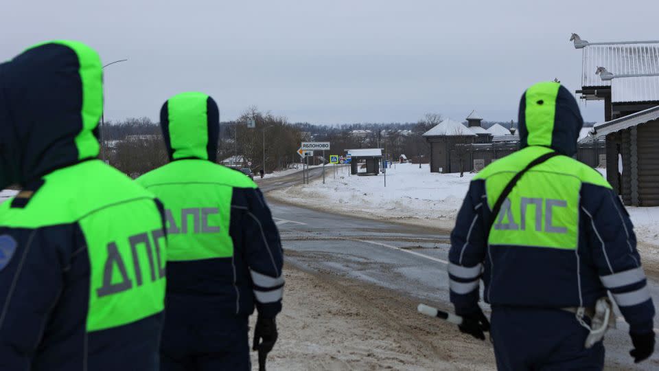 Traffic officers block off a road near the crash site of the IL-76 plane outside the village of Yablonovo, Russia, January 24, 2024. - Stringer/Reuters