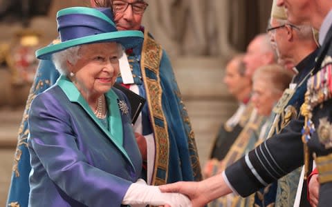 The Queen wore a royal blue silk coat with a turquoise collar over a dress in the same colour for the service - Credit: SIMON DAWSON /Reuters